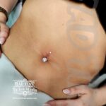 36Professional Piercing Liverpool home new ognialna zagubiona 36 kafelkow Professional navel piercing showcase by Mad Time Tattoo Studio, featuring a titanium curved barbell with double clear crystals on a female client's belly button.