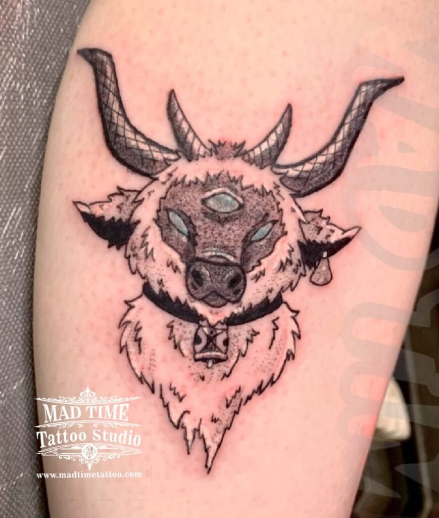 Dark blackwork tattoo of a detailed Baphomet horned goat head with mystical symbols on a forearm.