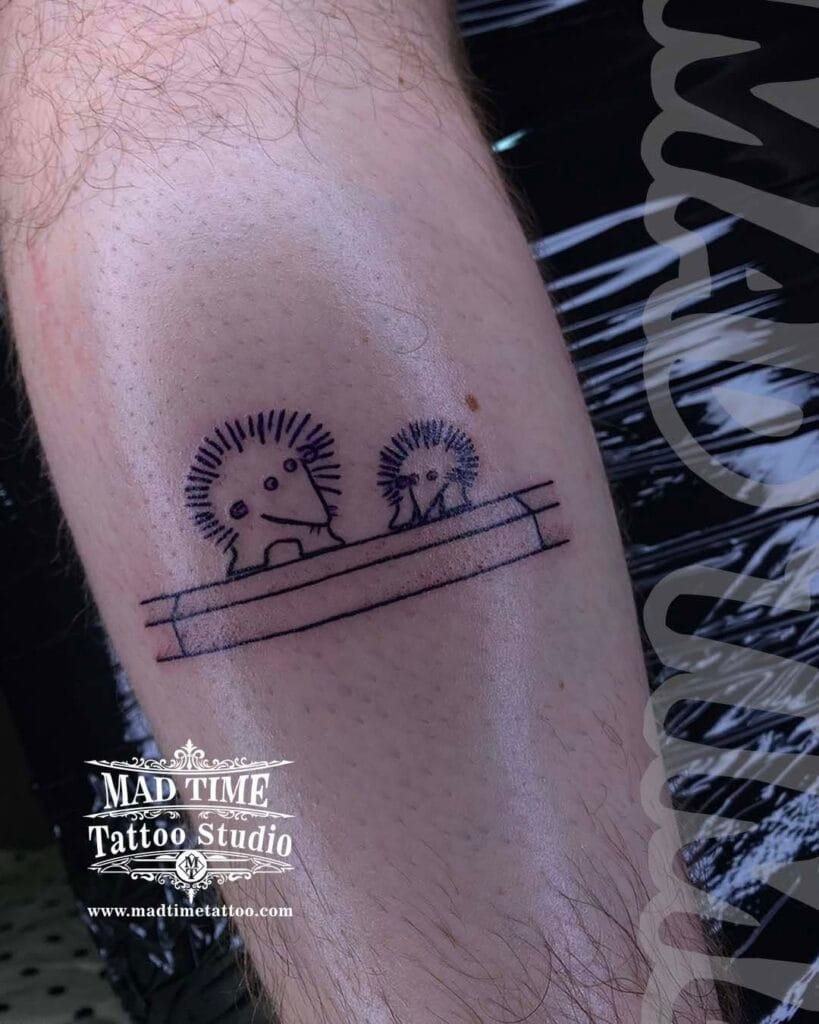 Tiny minimal blackwork tattoo showing simplified landscape rectangular frames on an arm.