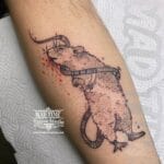 Home new Sketch style blackwork tattoo of a rat or mouse with fine lines and textured shading on an arm.