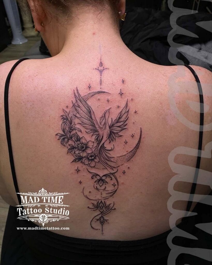 Delicate dotwork and fine line tattoo of a rising phoenix bird silhouette against a full moon on a woman's spine.