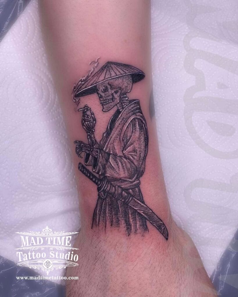 Detailed fine line and dotwork tattoo of a samurai skeleton wearing a traditional straw hat, smoking a cigarette, and holding a katana sword on a forearm.