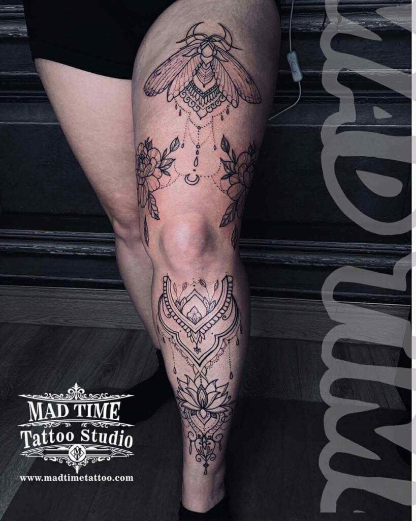 Extensive fine line leg sleeve tattoo showcasing detailed mandalas and intricate geometric patterns.