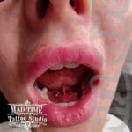 36Professional Piercing Liverpool home new ognialna zagubiona 36 kafelkow Professional lingual frenulum piercing showcase by Mad Time Tattoo Studio, featuring a titanium circular barbell hoop precisely placed through the tongue web underlip frenulum of a client.