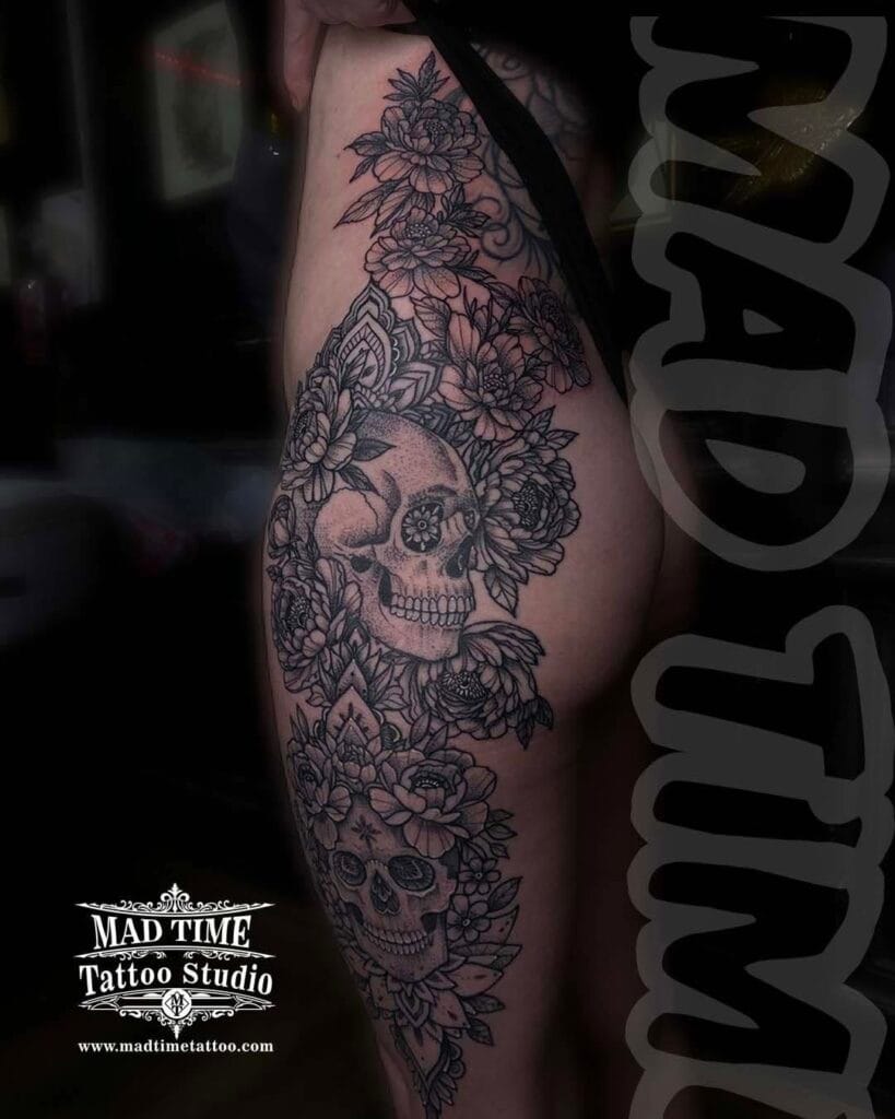 Massive black and grey ornamental tattoo covering a woman's entire side from the bra line down the ribs, hip, and outer thigh.