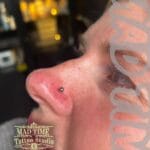 36Professional Piercing Liverpool home new ognialna zagubiona 36 kafelkow Professional nostril piercing showcase at Mad Time Tattoo Studio, featuring a classic titanium ball stud earring on a female client's nose.
