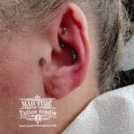 36Professional Piercing Liverpool home new ognialna zagubiona 36 kafelkow Professional rook piercing showcase by Mad Time Tattoo Studio, featuring a curved titanium barbell in the upper inner cartilage, paired with a crystal conch cluster piece and a round tragus stud on a female client.