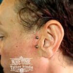 36Professional Piercing Liverpool home new ognialna zagubiona 36 kafelkow Professional sideburn surface piercing showcase by Mad Time Tattoo Studio, featuring a vertical titanium surface barbell with metallic beads placed right next to the tragus cartilage on a client's cheek.