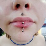 36Professional Piercing Liverpool home new ognialna zagubiona 36 kafelkow Professional cyber bites piercing showcase at Mad Time Tattoo Studio, featuring a symmetrical vertical labret piercing on the lower lip and a centered medusa philtrum piercing stud on the upper lip of a client.