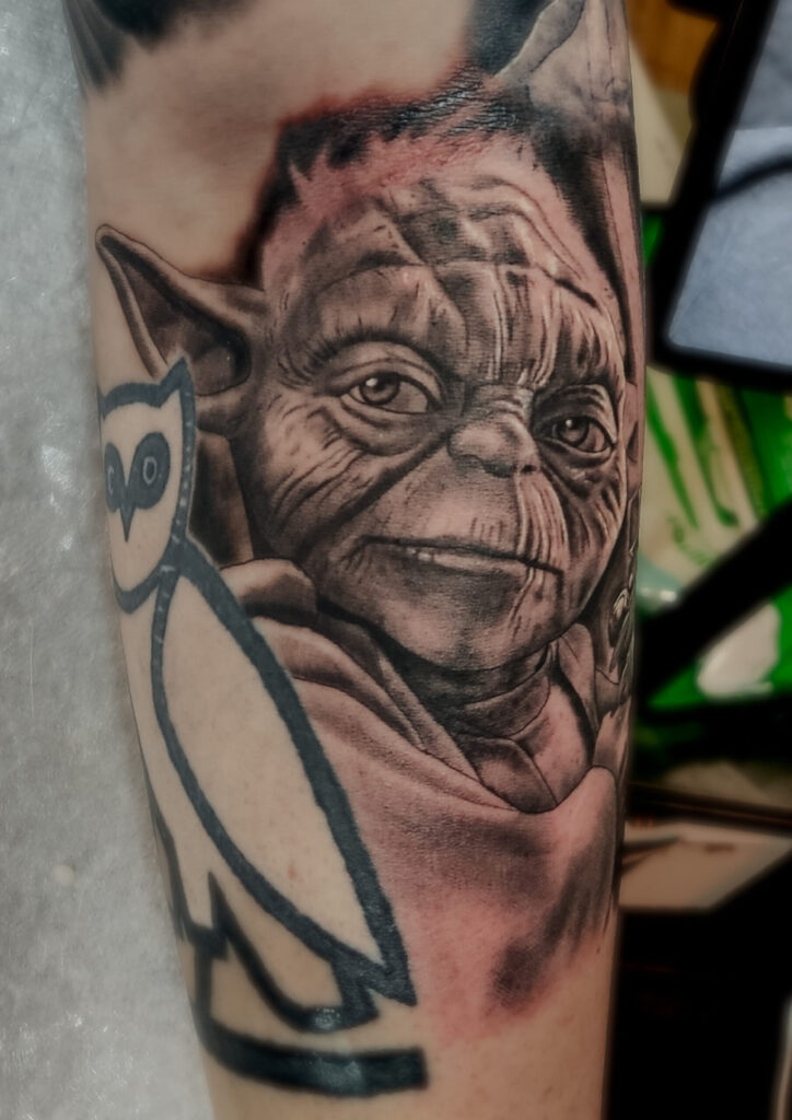 Realistic black and grey Star Wars Yoda portrait tattoo with fine skin details by guest artist Pablo from Spain at our studio