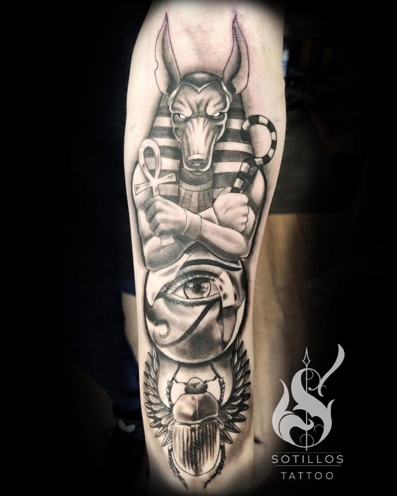 Egyptian mythology sleeve tattoo with Anubis Eye of Horus and sacred scarab by guest artist Pablo from Spain at our studio