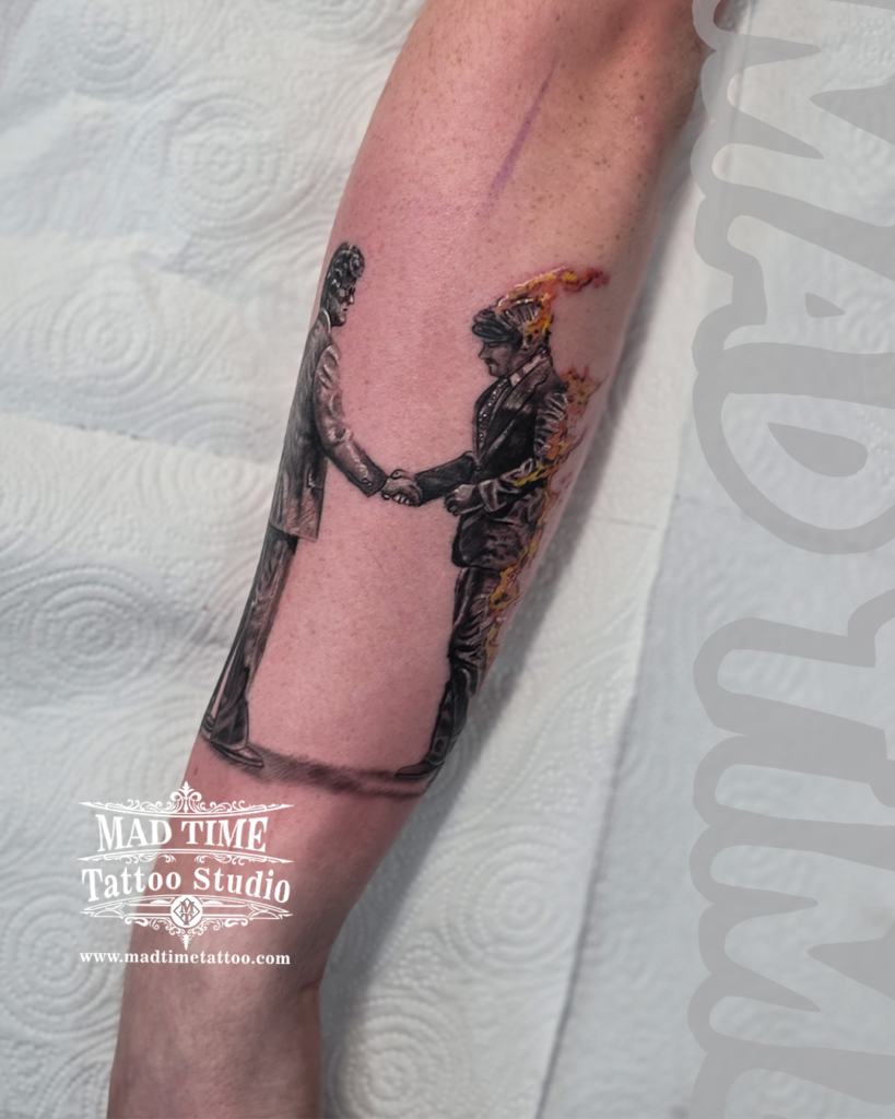 Precise micro realism tattoo replicating Pink Floyd Wish You Were Here album cover of two businessmen shaking hands on fire by our studio