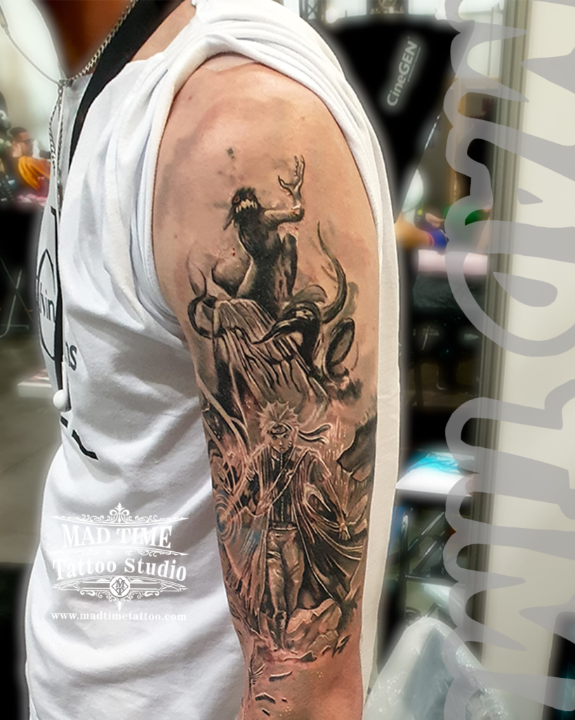 Anime Tattoos Liverpool • Black and grey realism tattoo of Naruto Uzumaki in his sage cloak below the monstrous Nine Tailed Fox Kurama on an upper arm sleeve by resident artist Henry at Mad Time Tattoo Studio
