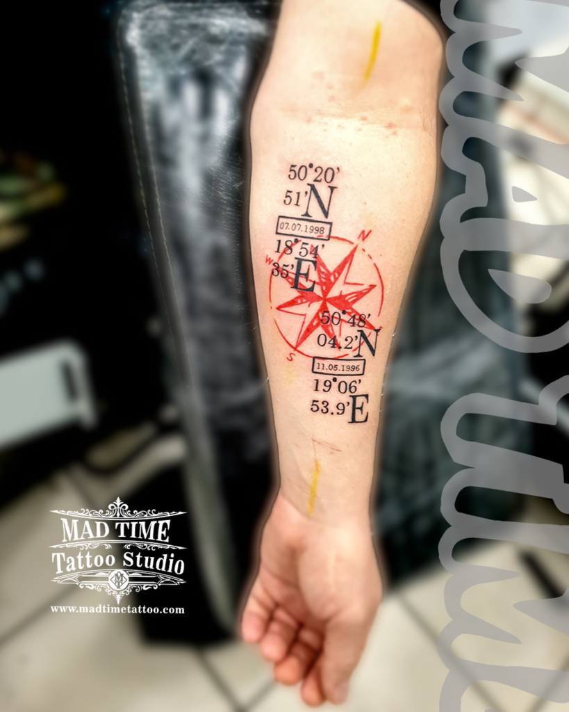 Minimalist Trash Polka forearm tattoo featuring a bold red windrose compass surrounded by sharp black geographical coordinates and birth dates by our studio