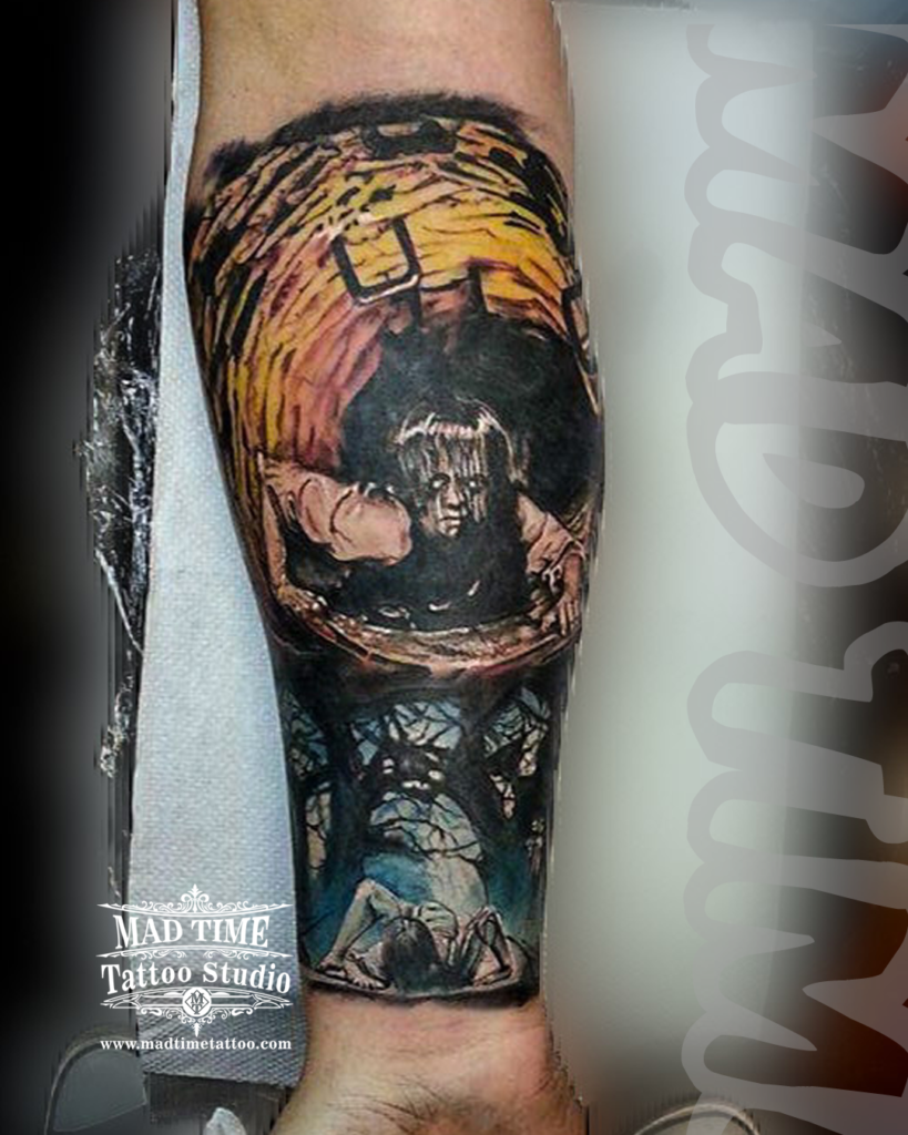 Horror movie realism tattoo of Samara Morgan crawling out of the stone well from The Ring with a forest reflection by our studio