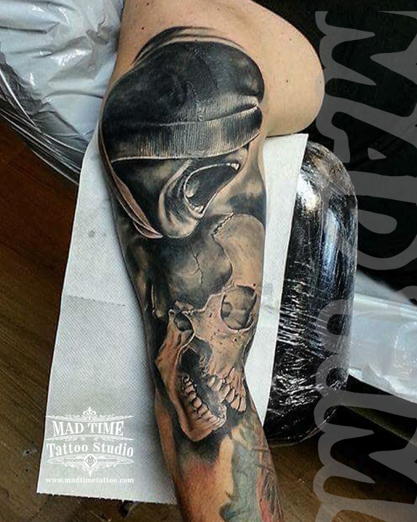 Dark art surrealism arm sleeve tattoo morphing a screaming face in a winter beanie with a texturized human skull by our studio